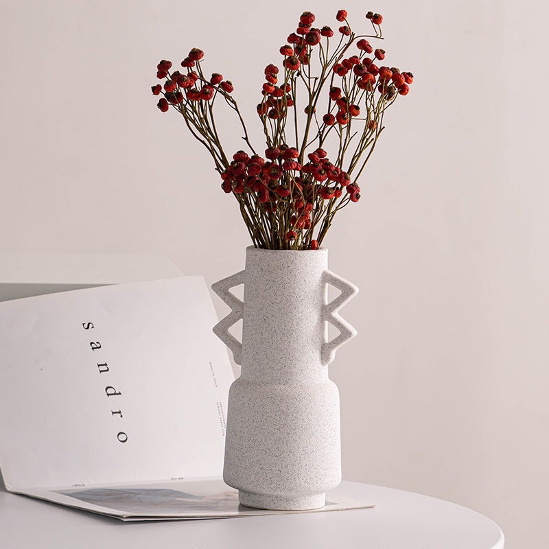 Dried wildflowers in grey clay or ceramic vase standing on table as  decoration Stock Photo by Pressmaster